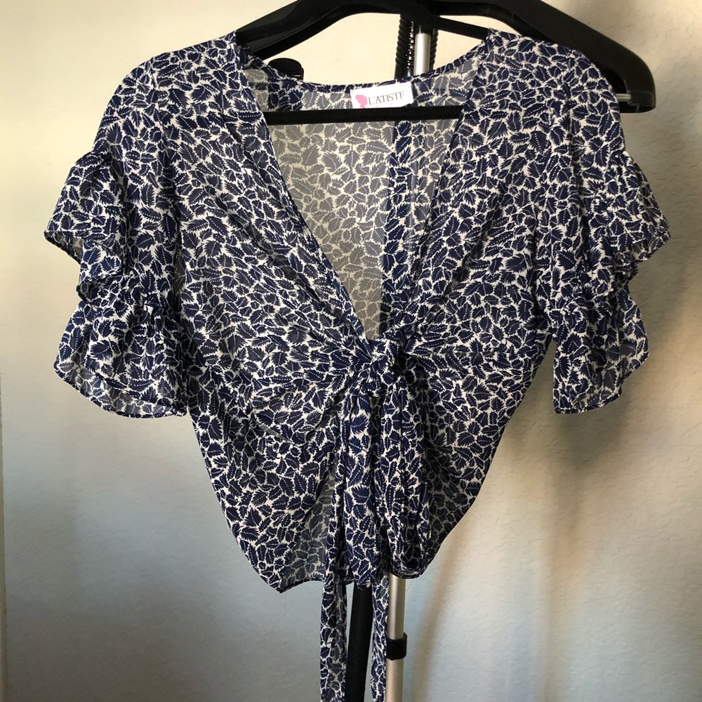 Front tie crop top with ruffle sleeves.